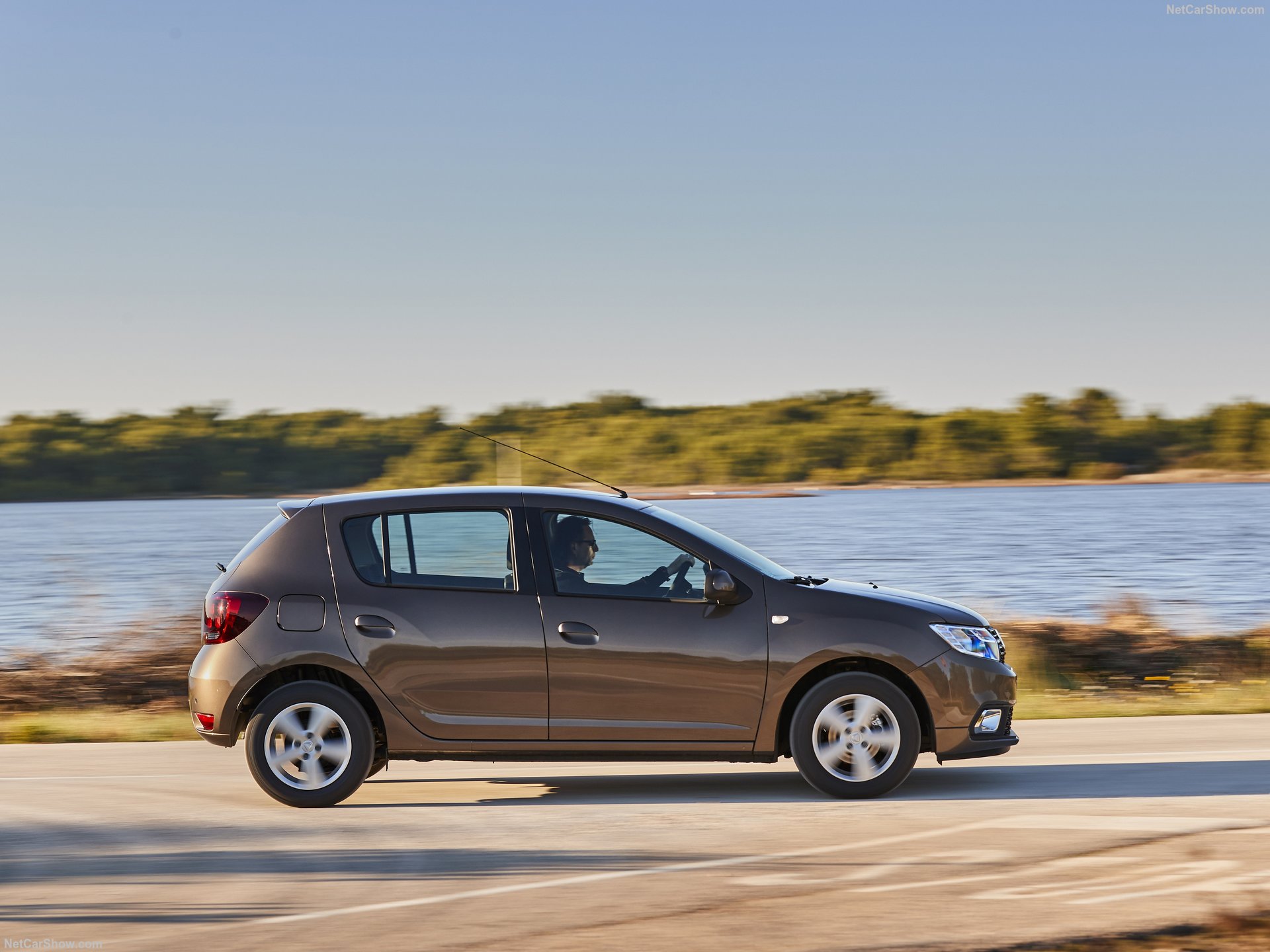 Side profile of a Dacia Sandero 2018 rental car parked in Saranda, Albania.